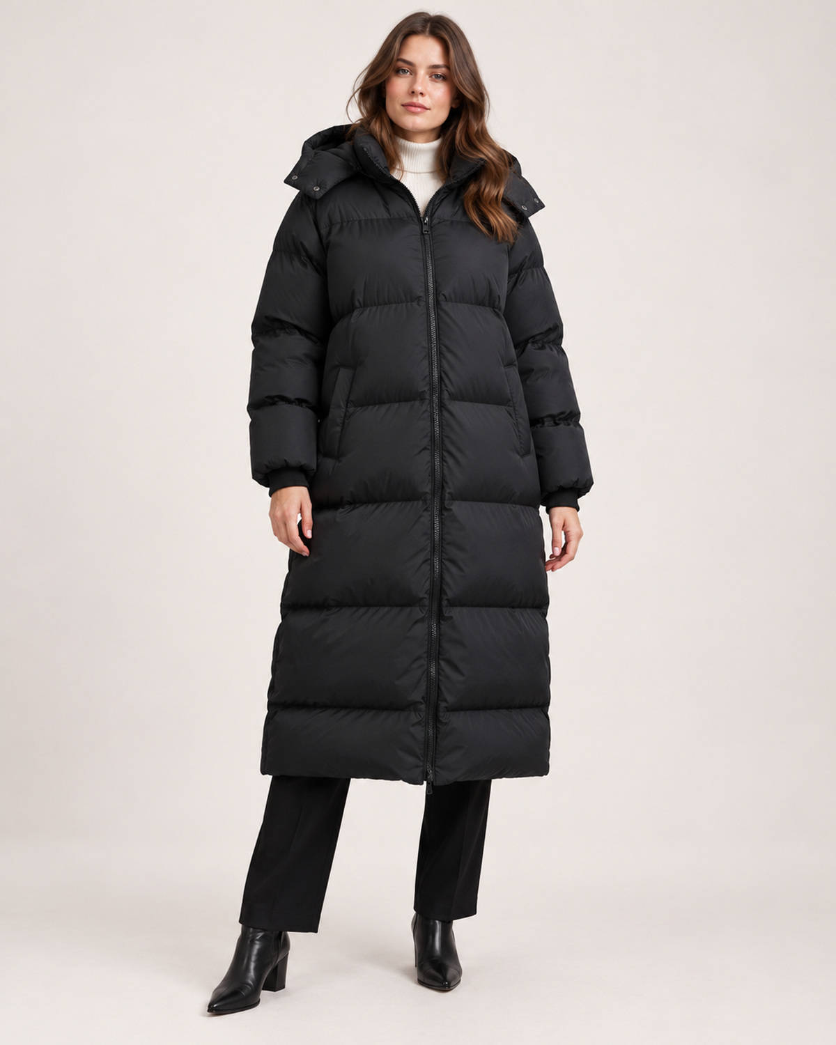 Women's black long hooded puffer coat closed front view