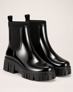 Women's black gloss Chelsea Wellington boots pair front three-quarter view