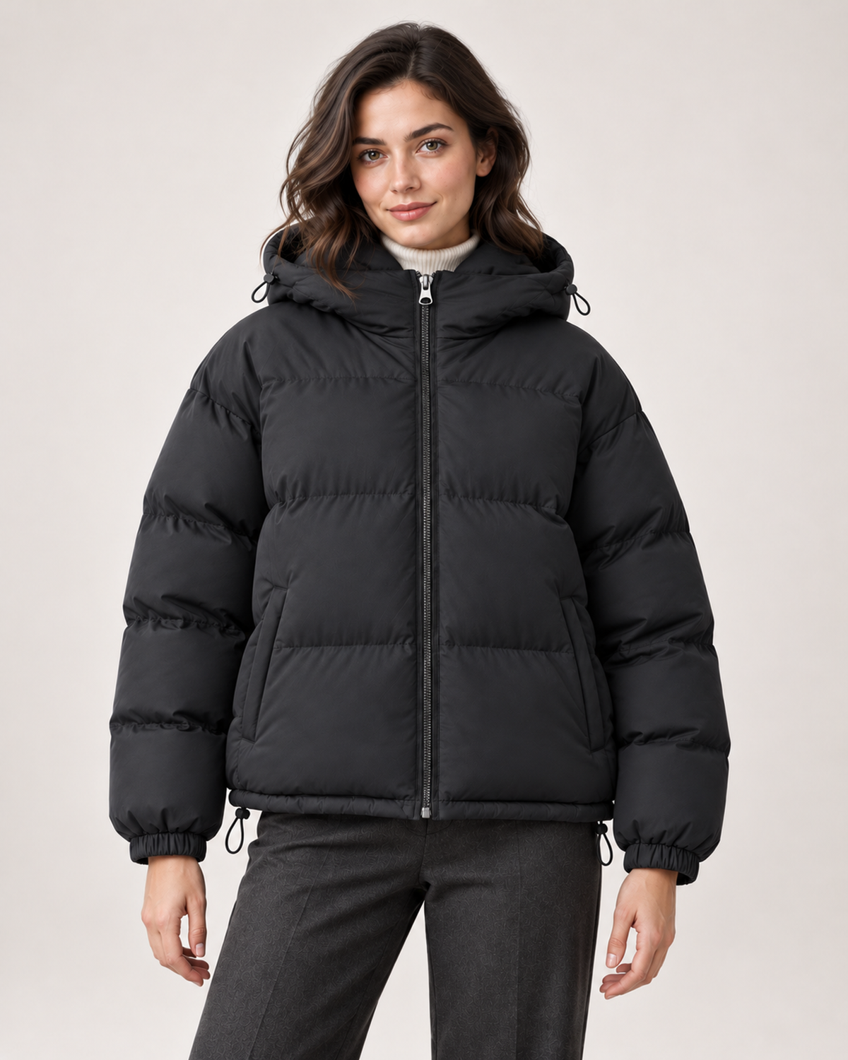 Women's black puffer jacket with hood and drawcord hem front view