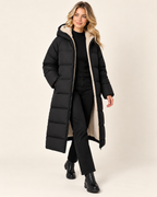 Women's black long puffer coat with hood walking view