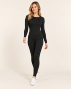 Women's black crew neck thermal base layer set walking view