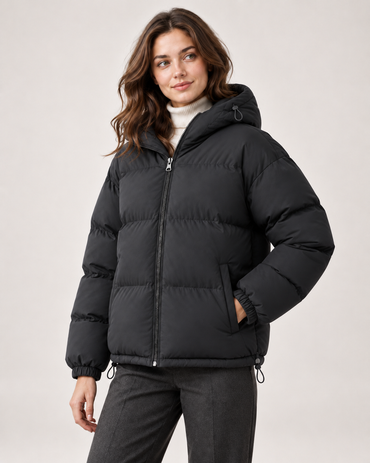 Women's black hooded puffer jacket three quarter view