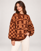Women's gingerbread Christmas jumper shown from a three-quarter angle