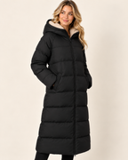 Women's black long puffer coat with hood three quarter view