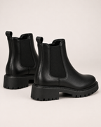 Women's black Chelsea boots heel and lug sole view