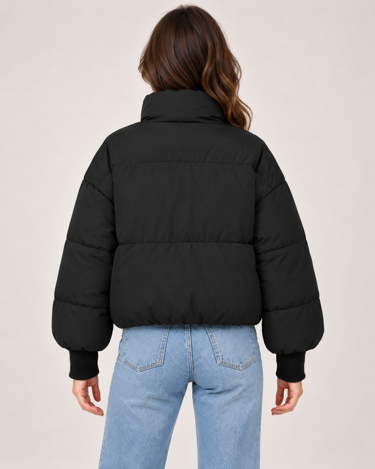 Back view of women's black cropped puffer jacket