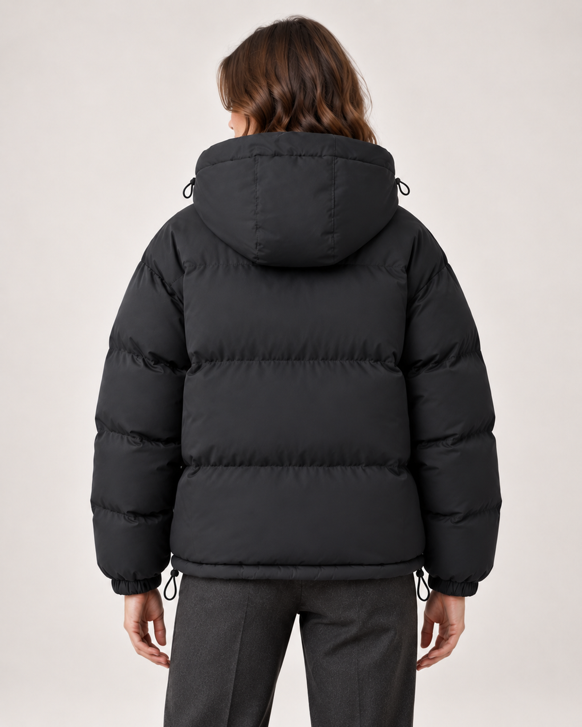 Women's black hooded puffer jacket back view