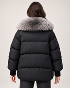 Women’s black puffer jacket with faux fur collar rear view
