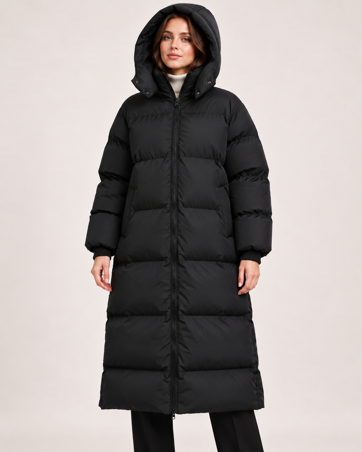 Women's black long puffer coat closed with hood up