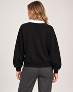Back view of women's black collared jumper