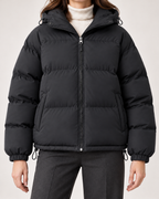 Women's black hooded puffer jacket zip and drawcord detail