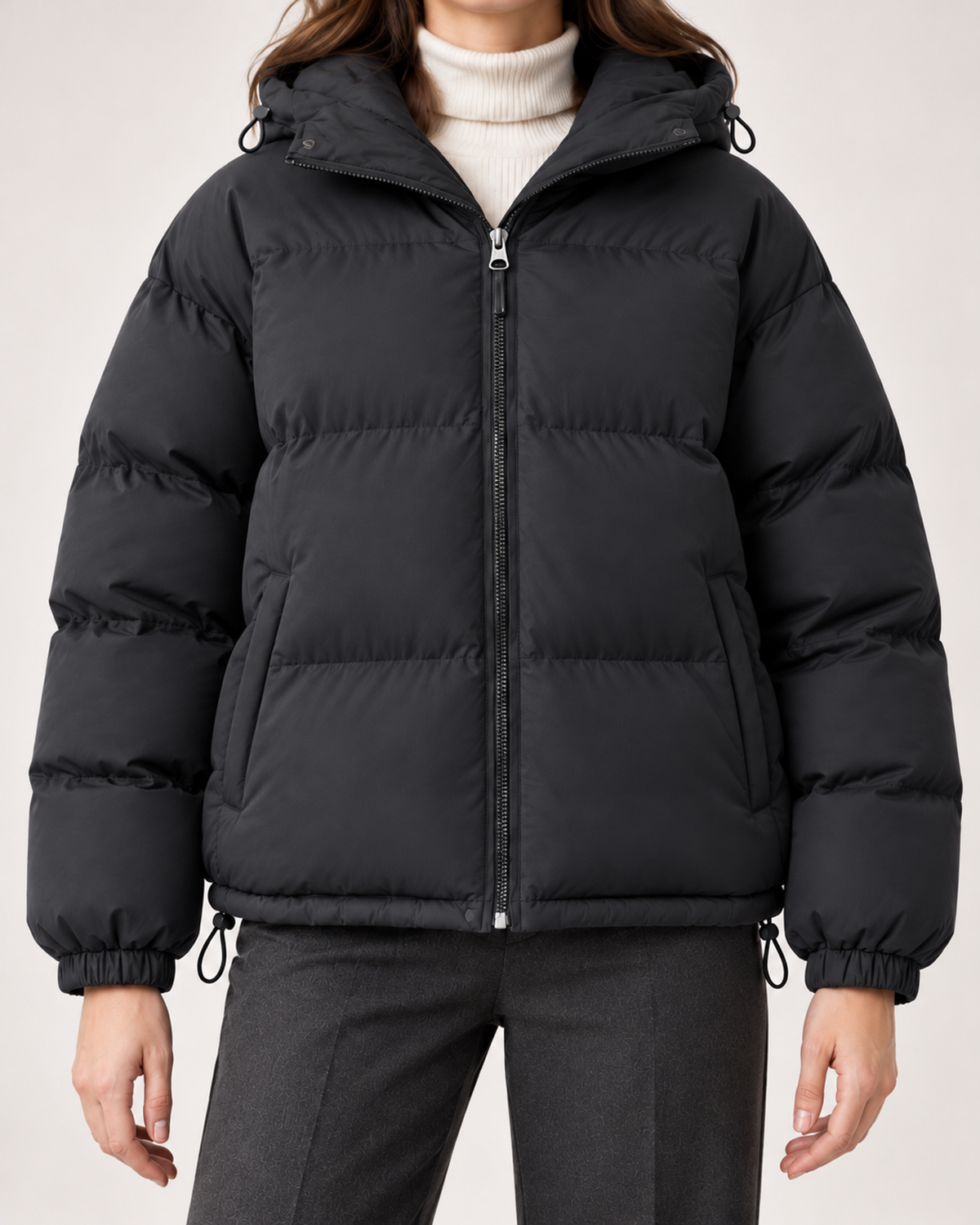 Women's black hooded puffer jacket zip and drawcord detail