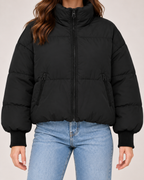 Close view of women's black cropped puffer jacket high neck and zip details
