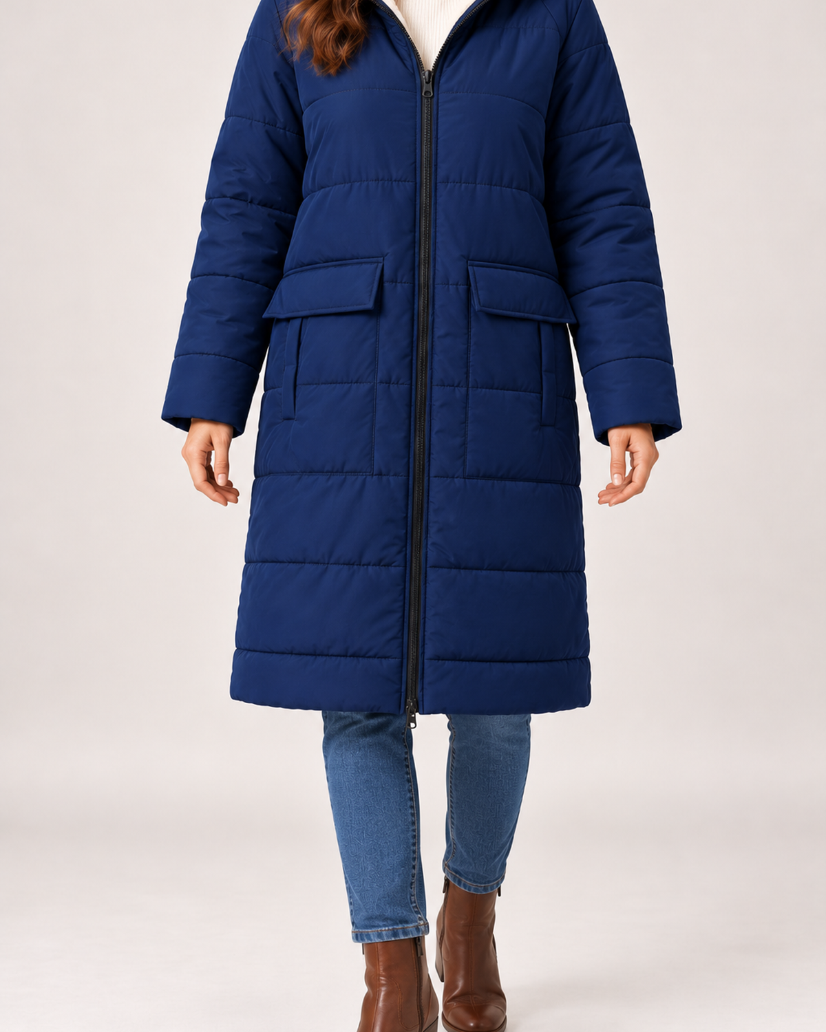 Close view of women's navy long puffer coat hood and pocket details