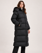 Women's black long hooded puffer coat side and pocket view