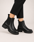 Women's black chunky Chelsea ankle boots worn