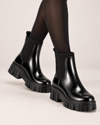 Women's black gloss Chelsea Wellington boots worn view
