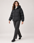 Women's black hooded puffer jacket full length styling view