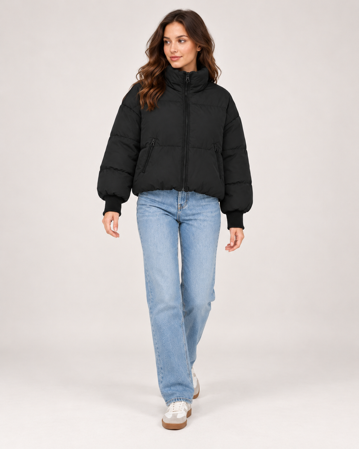 Women's black cropped puffer jacket styled with jeans